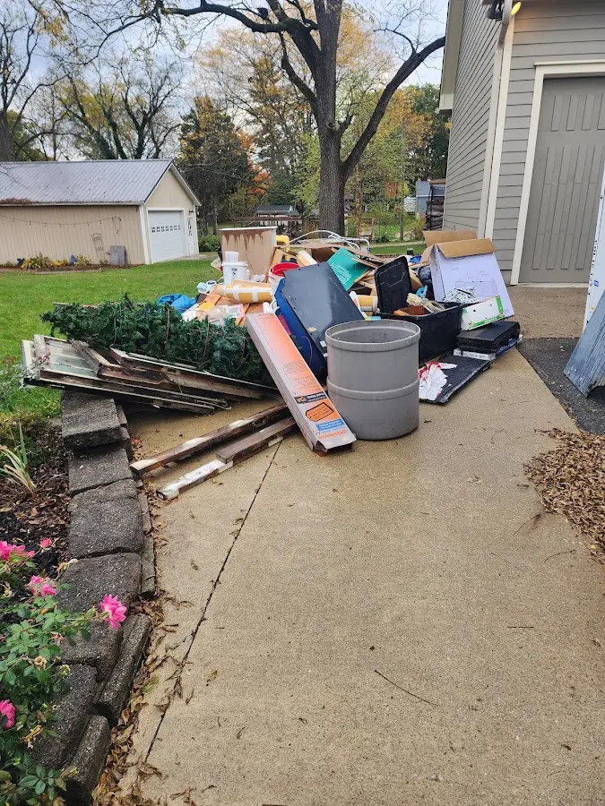 Dumpster being loaded with debris for 12 Yard Dumpster Rental in Upper Moreland